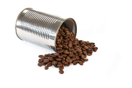 Coffee beans rolling out of a toppled tin canの写真素材