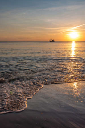 At the beach in the evening, with a beautiful sunlightの写真素材