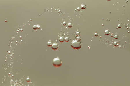 Light air bubbles flowing in waterの写真素材