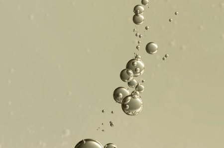Nice golden champagne bubbles soars over a blurred background