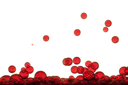 Red air bubbles flowing toward the water surfaceの写真素材