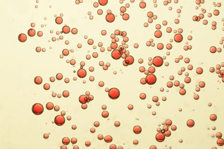 Red carbonated bubbles over a blurred background