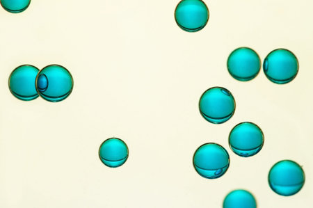 Some big blue air bubbles float over a light background
