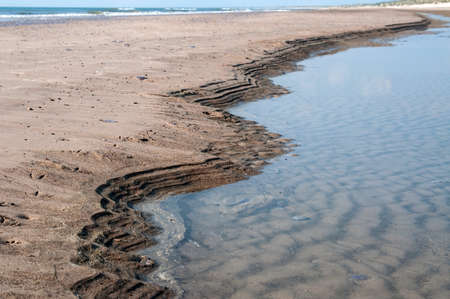 Nice patterns in the sand next to the seasideの写真素材