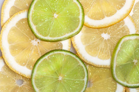 Green and yellow slices of citrus fruitの写真素材