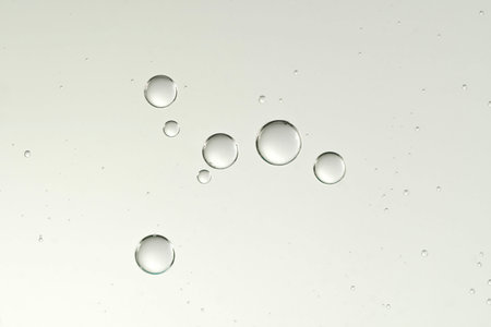 Beautiful shiny air bubbles soars over a blurred background