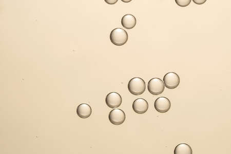 Golden shiny fizz bubbles over a blurred backgroundの写真素材