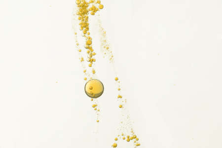 Yellow bubbles flows over a blurred backgroundの写真素材