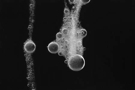 White water bubbles isolated over a black background.の写真素材