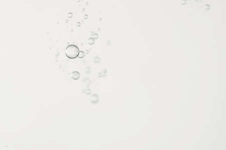 Small bubbles is falling over a gray and blurred background.の写真素材