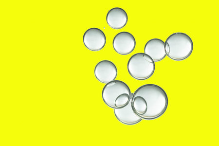 Light air bubbles isolated over a yellow background.