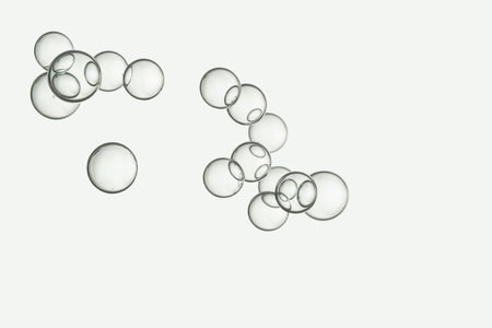 Light beige blurred bubbles soars close together.