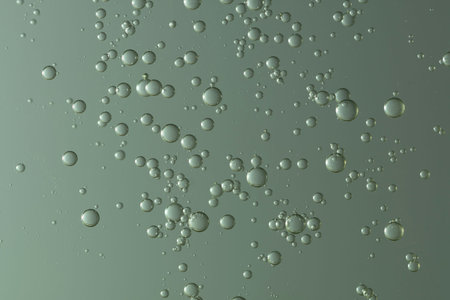 Shiny color gradient bubbles floiws over graan background.