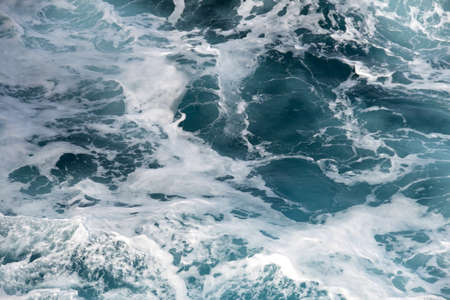 Dark blue waves meets near the coastelineの写真素材