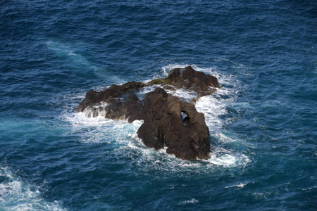 A stone rock in the blue ocean