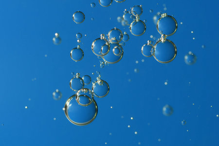 Blue air bubbles rising toward the water surface.