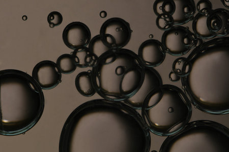 Dark bronze colored bubbles, fizz, carbonated.の写真素材