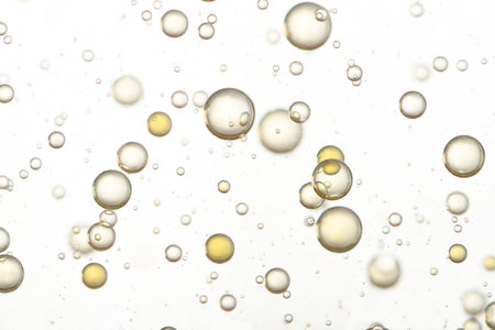 Yellow fizz flows in a glass. Blurred background, flying.の写真素材