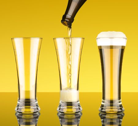 filling a glass of beerの写真素材
