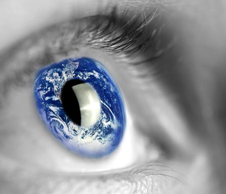 earth globe in woman's eyeの写真素材