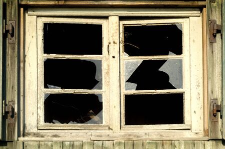broken window on an old houseの写真素材