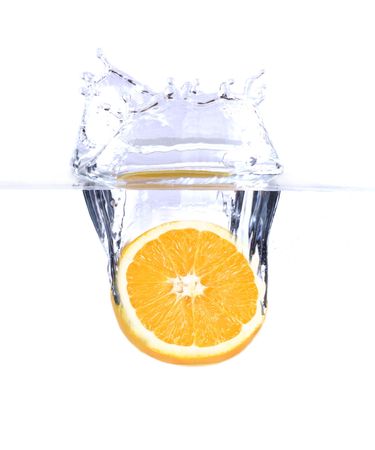 fresh orange splashing into waterの写真素材