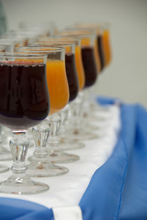 Glasses with vine snd juice in a row