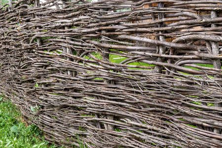 rustic wicker fence at an angle, close upの写真素材