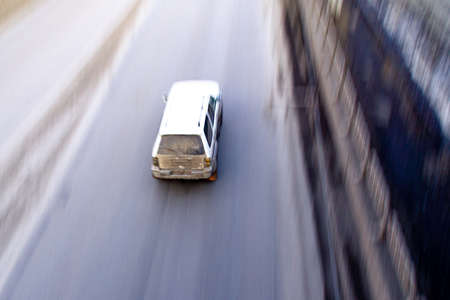 white car moves on the road, top view with blurの写真素材