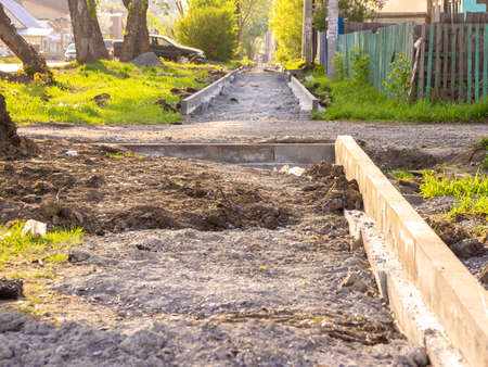 curb installation and sidewalk construction outside the city, selective focusの写真素材