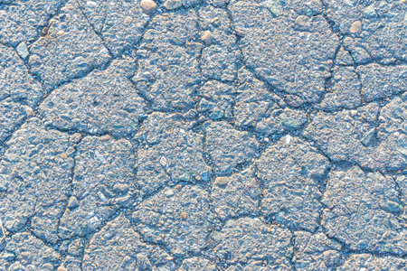 low contrast texture of cracked old asphalt, old road or sidewalk background