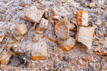 Remains of destroyed old buildings, fragments of old bricks on frozen ground