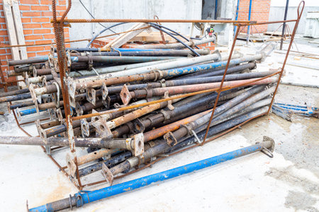 a bunch of telescopic jack stands for mounting the formwork of a monolithic ceiling lie in a cradle...