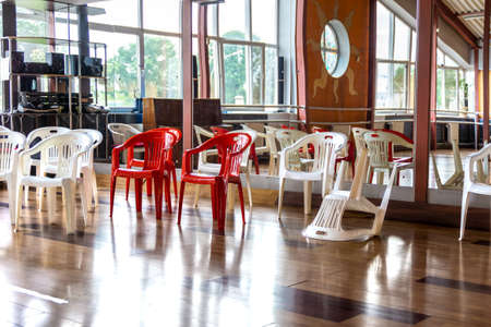 there are plastic chairs for guests in the dance hall with a mirror wall, waiting for the start of the performance, selective focusの写真素材