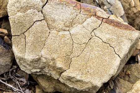 a piece of sandstone cracked under the influence of atmospheric phenomena, selective focusの写真素材