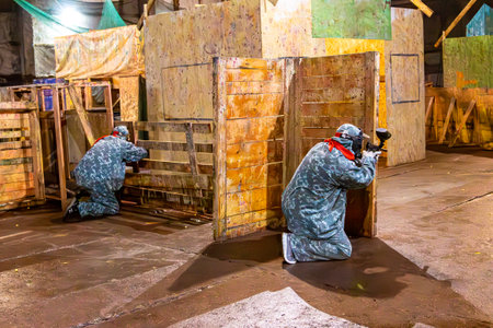 indoor paintball - attacking the enemy from cover, selective focusの写真素材