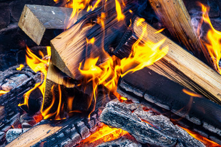 A fire burning in a home fireplace, representing the tradition of indoor warmth, family gatherings,...