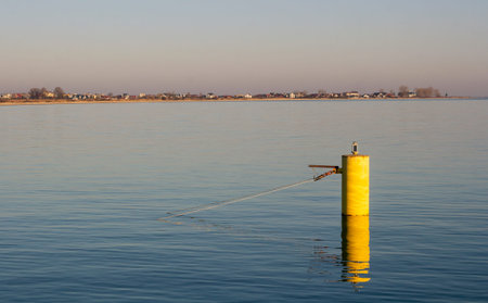 Yellow buoy in front of the entrance to the fishing port