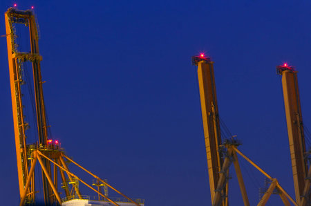 Port machines for unloading ships just before sunrise