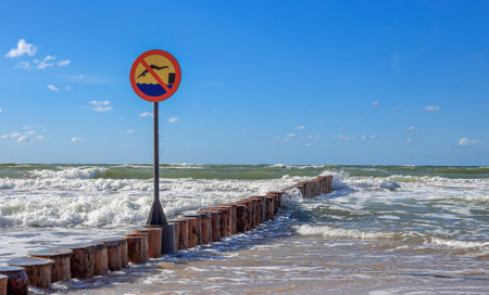 A sign prohibiting swimming on the breakwater in Polandの写真素材