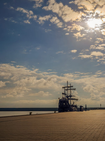 A wooden ship moored at the wharf at sunrise in Gdynia, Polandの写真素材
