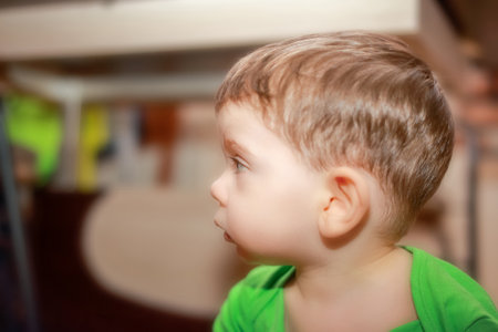 Portrait of a boy looking to the left side inside of the houseの写真素材