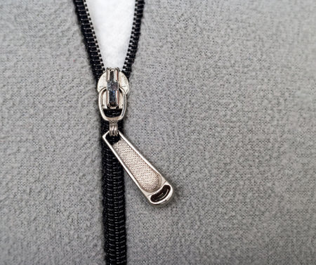 A silver zipper in a gray sweatshirtの写真素材