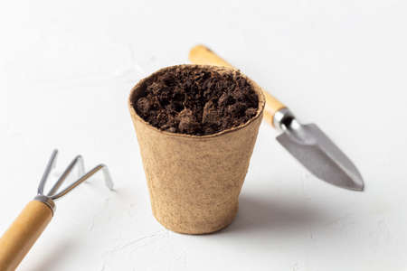 pot with earth rake and shovelの写真素材