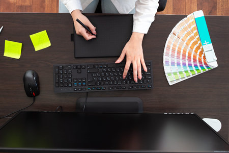 Designer works on a graphic tablet.