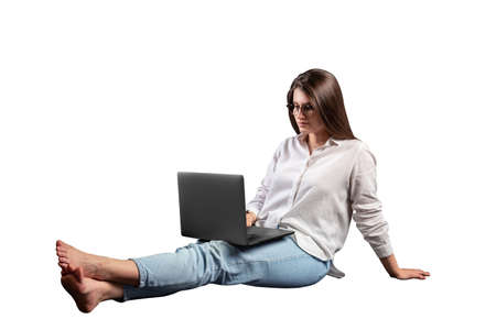 girl sitting on the floor with a laptopの写真素材