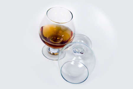 a glass of cognac and empty glassの写真素材