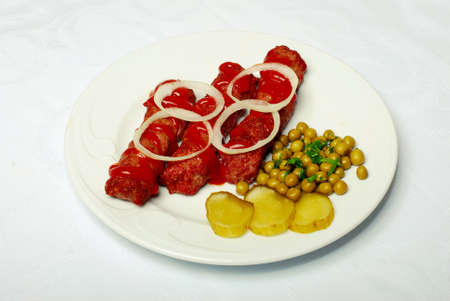 Sausages And Vegetables On The White Plateの写真素材