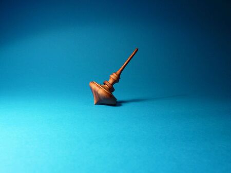 Spinning top on blue backgroundの写真素材