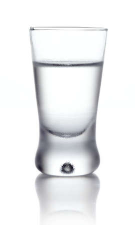 Studio shot of glass of vodka isolated on whiteの写真素材